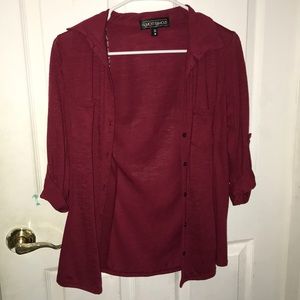 A dark red button down blouse
